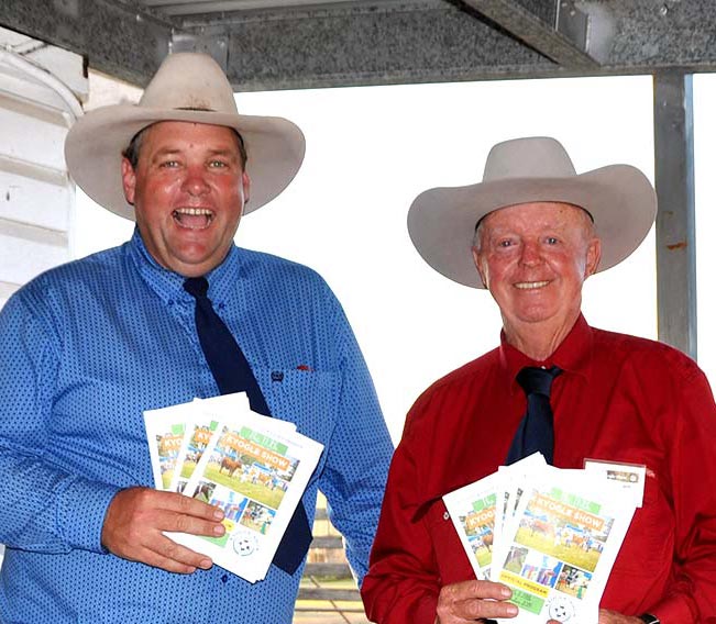 Two men from the P&H Society smiling and holding show programs